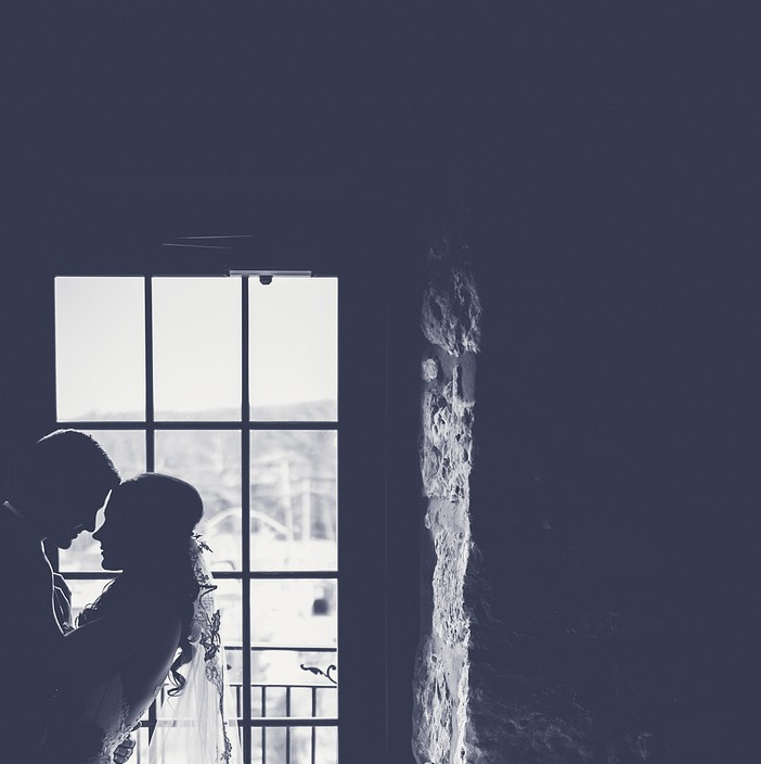 Bride and groom with wedding limousine in the USA